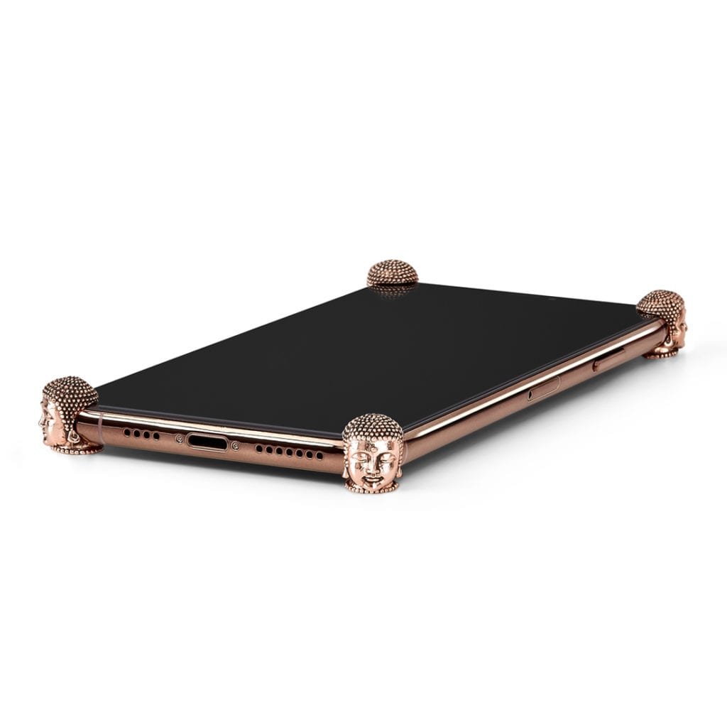 Rose Gold Buddha ICONS installed on all four corners of a bare iPhone 11