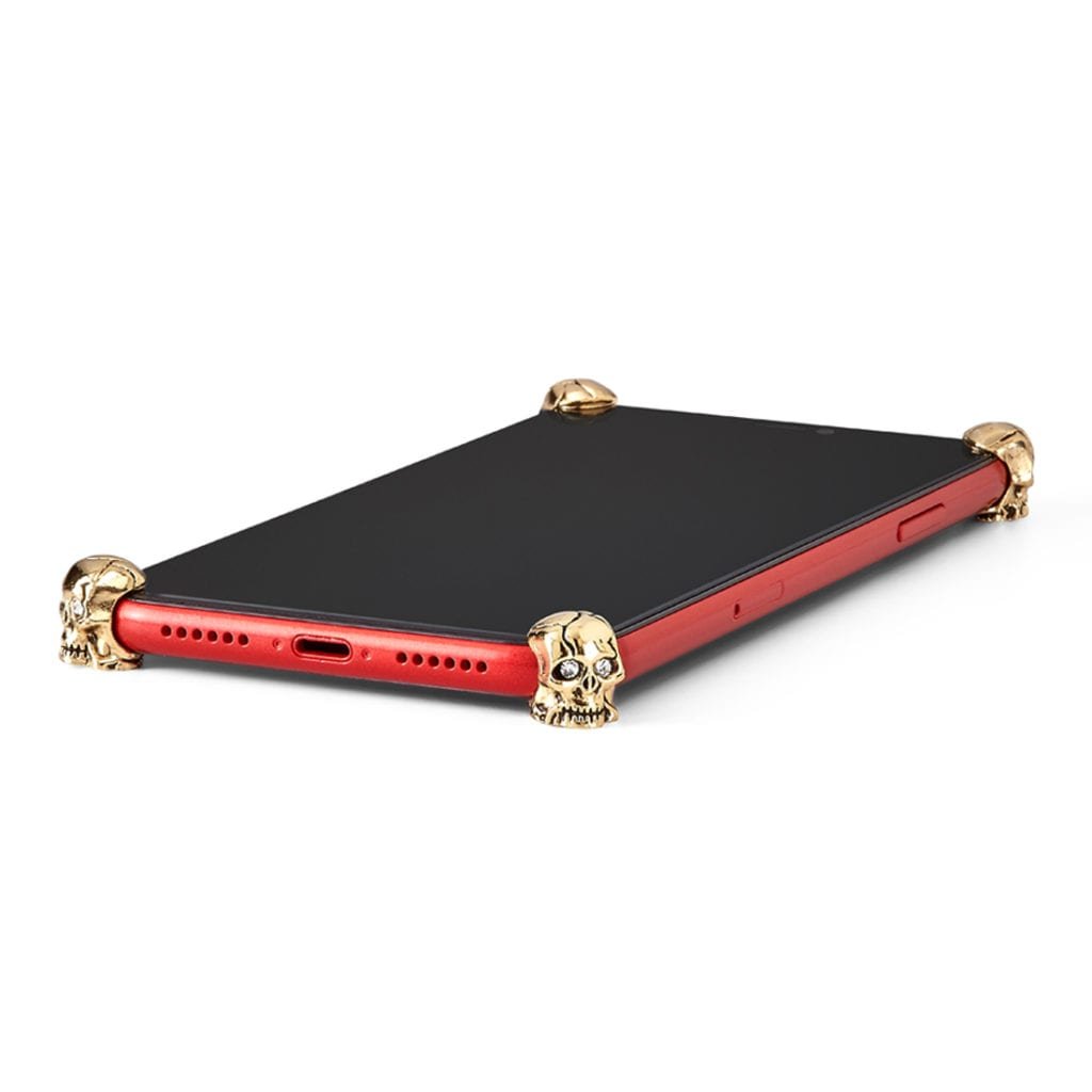 Gold Skull ICONS installed on all four corners of a bare iPhone 11