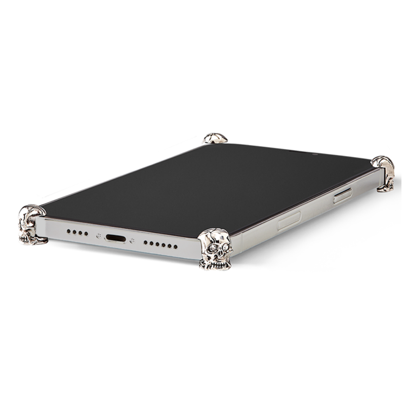 Silver Skull ICONS installed on all four corners of a bare iPhone 15 Pro / Pro Max