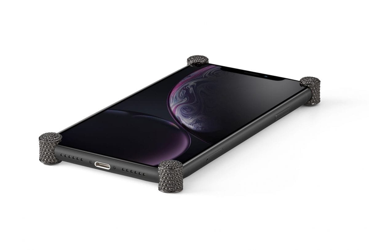 Carbon Dragon ICONS installed on all four corners of a bare iPhone XR