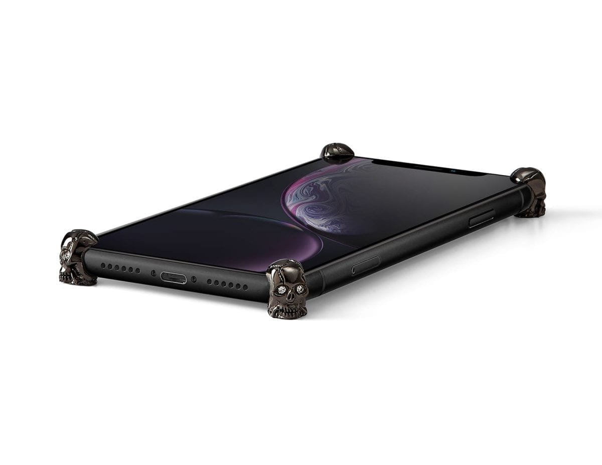Carbon Skull ICONS installed on all four corners of a bare iPhone XR
