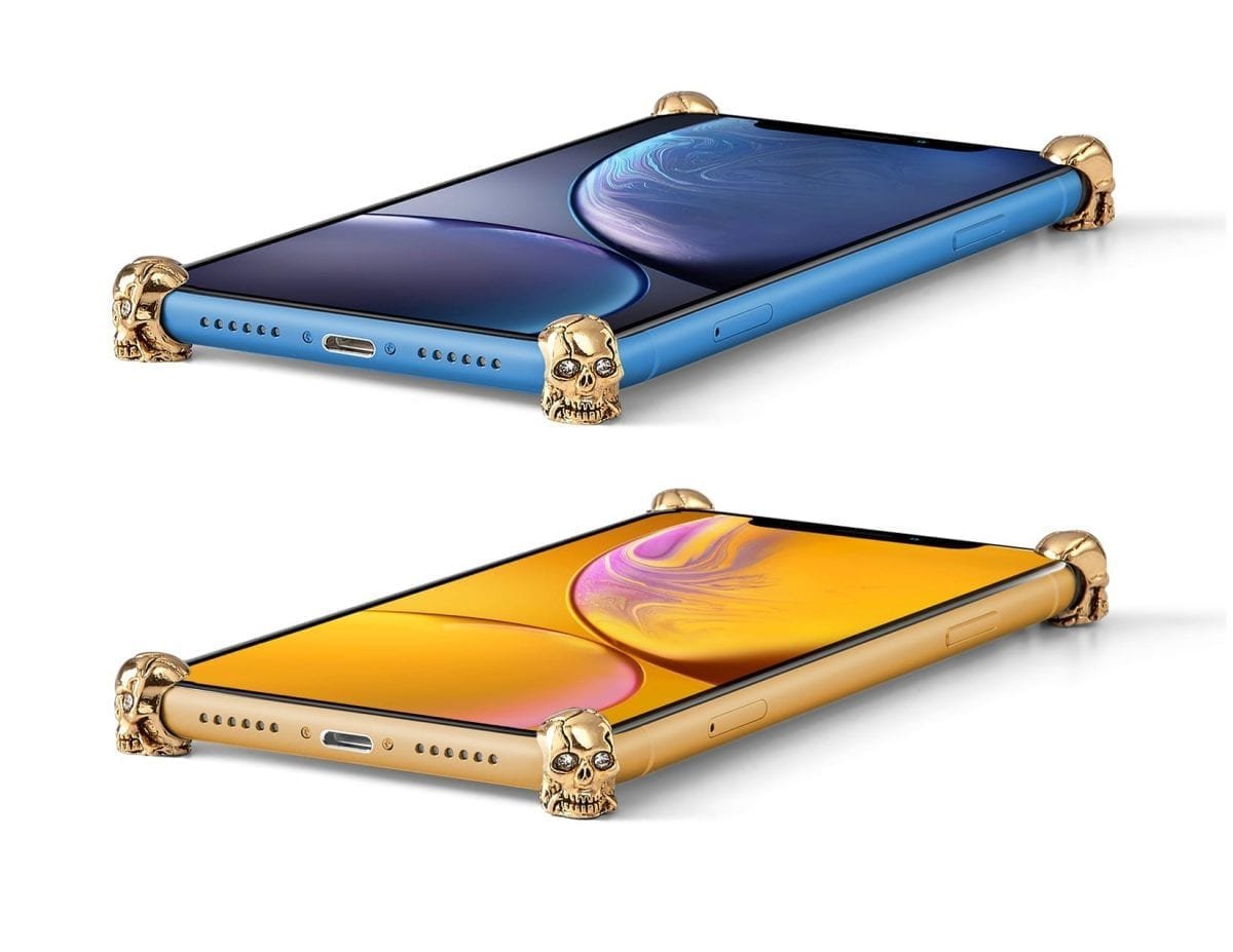 Gold Skull ICONS installed on all four corners of a bare iPhone XR